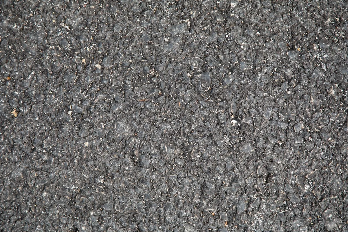 Close-up of an existing asphalt road surface texture before tack coat